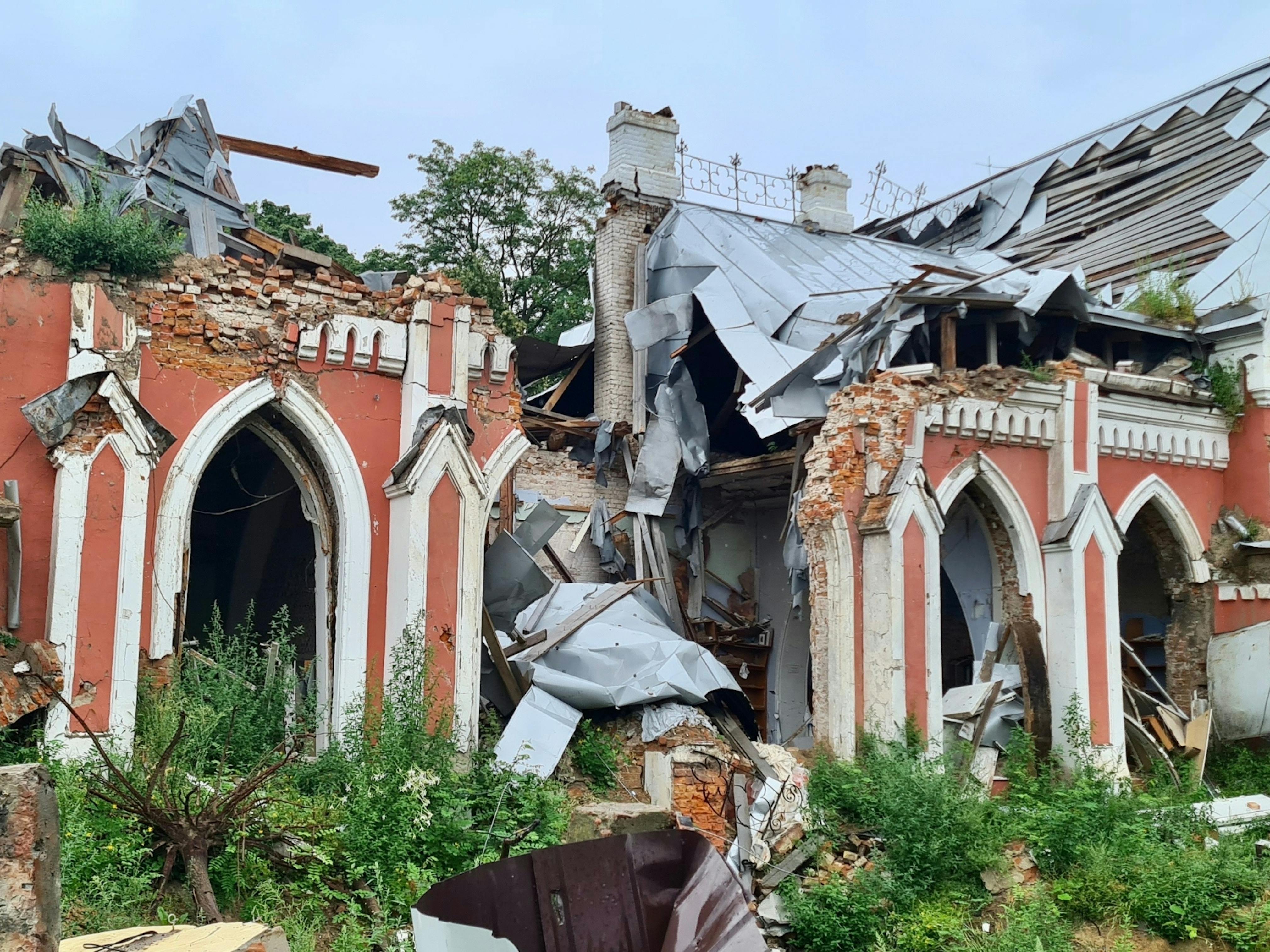 Heavily damaged building with debris strewn across scene