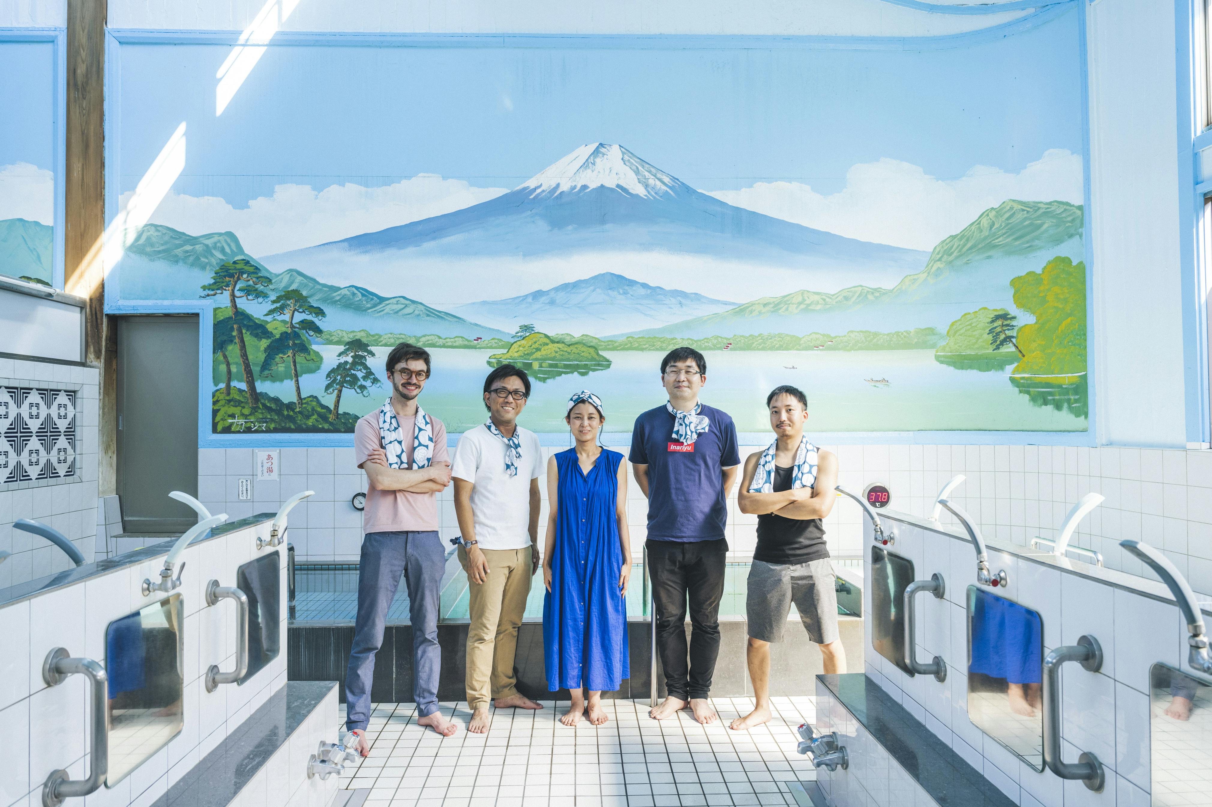 Sam (far left) with other S&amp;N Directors in front of the traditional Mt. Fuji bathhouse mural. Photo credit: S&amp;N.