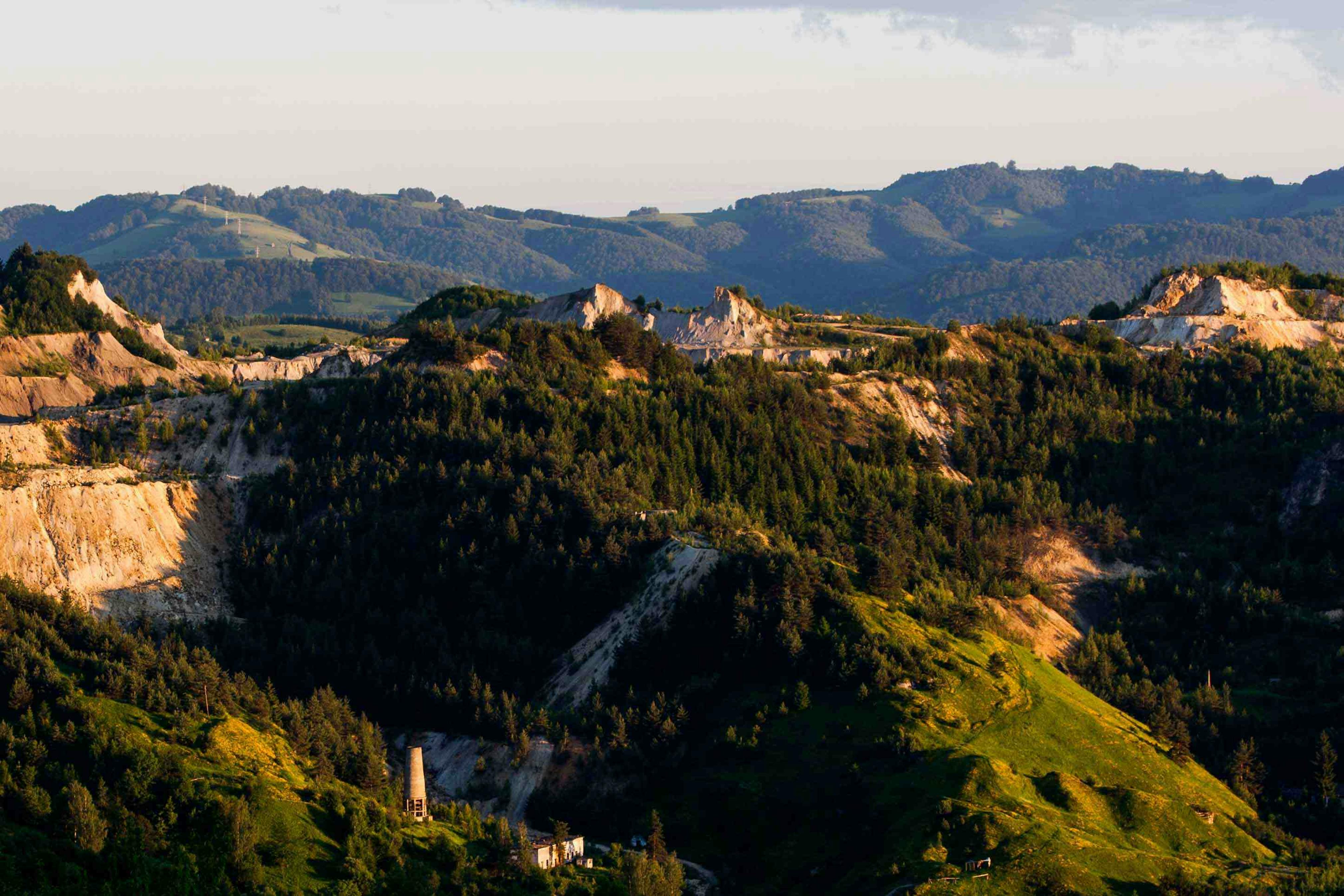 Traces of recent open-cast mining in Mt. Cetate. In the foreground, historical waste heaps from traditional mining, integrated into the landscape, 2016