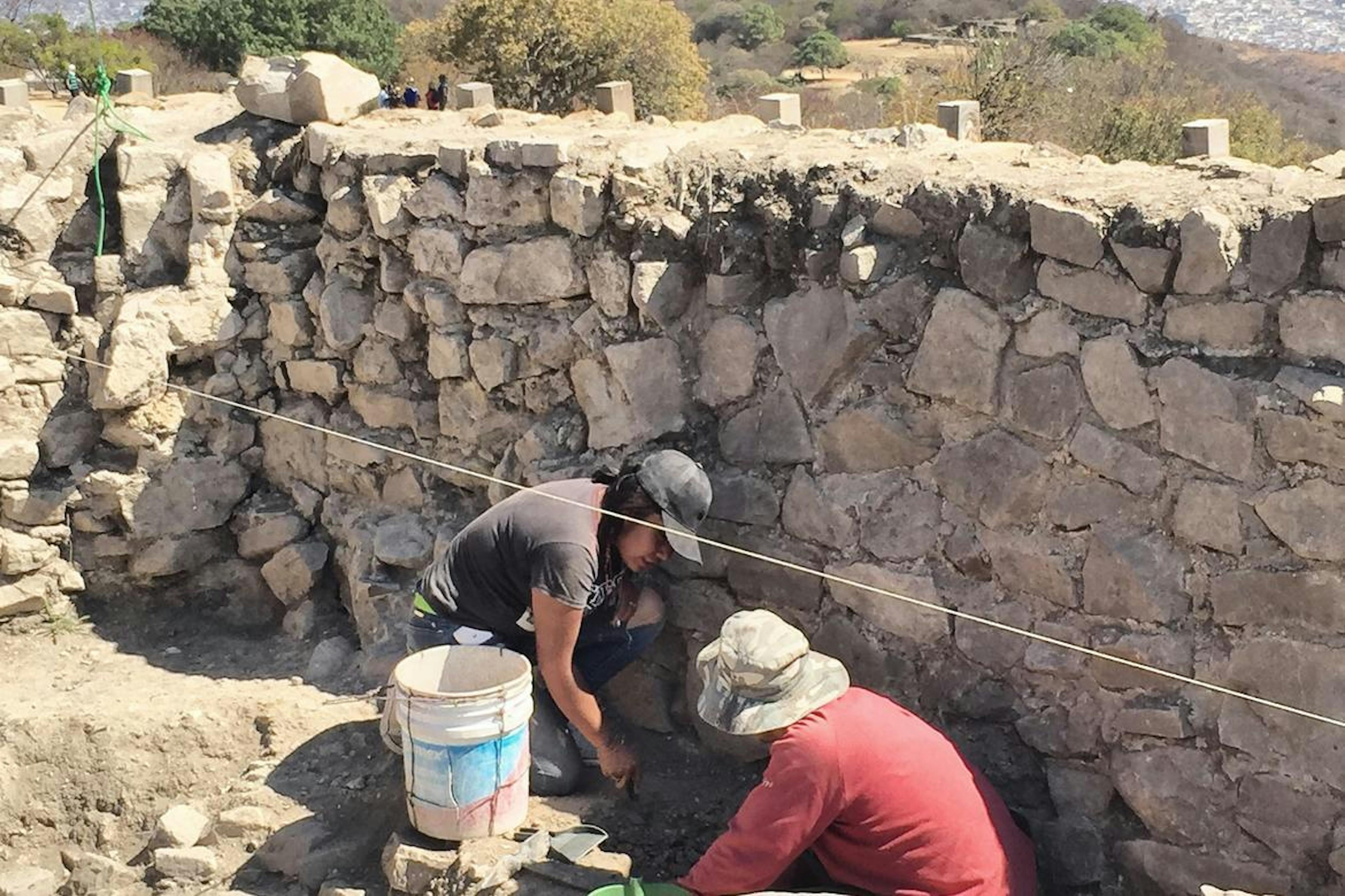 Removing, cleaning, and classifying  little archaeological findings on the top of a pyramid in Monte Albán.