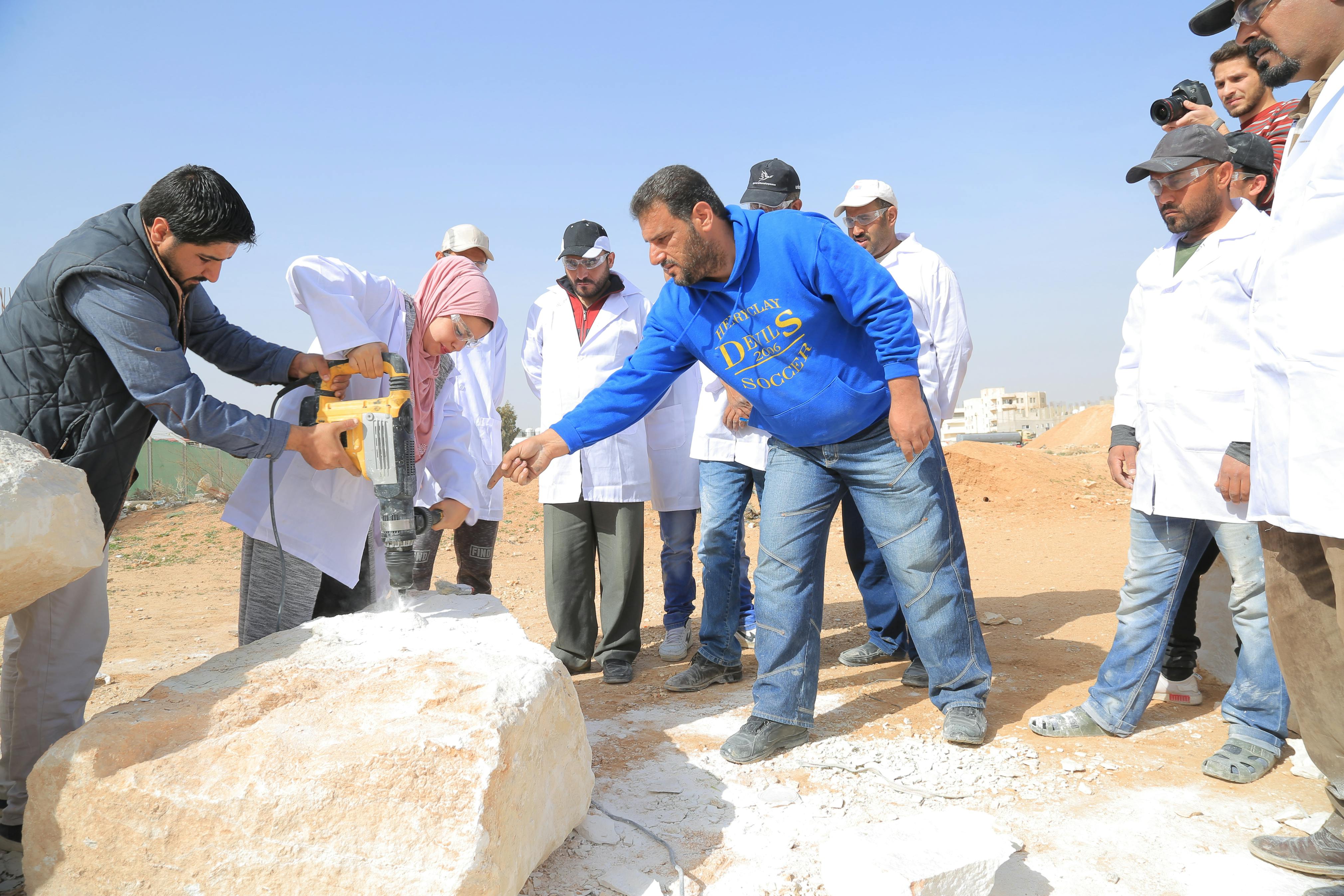 Students cutting stone block, April 2018