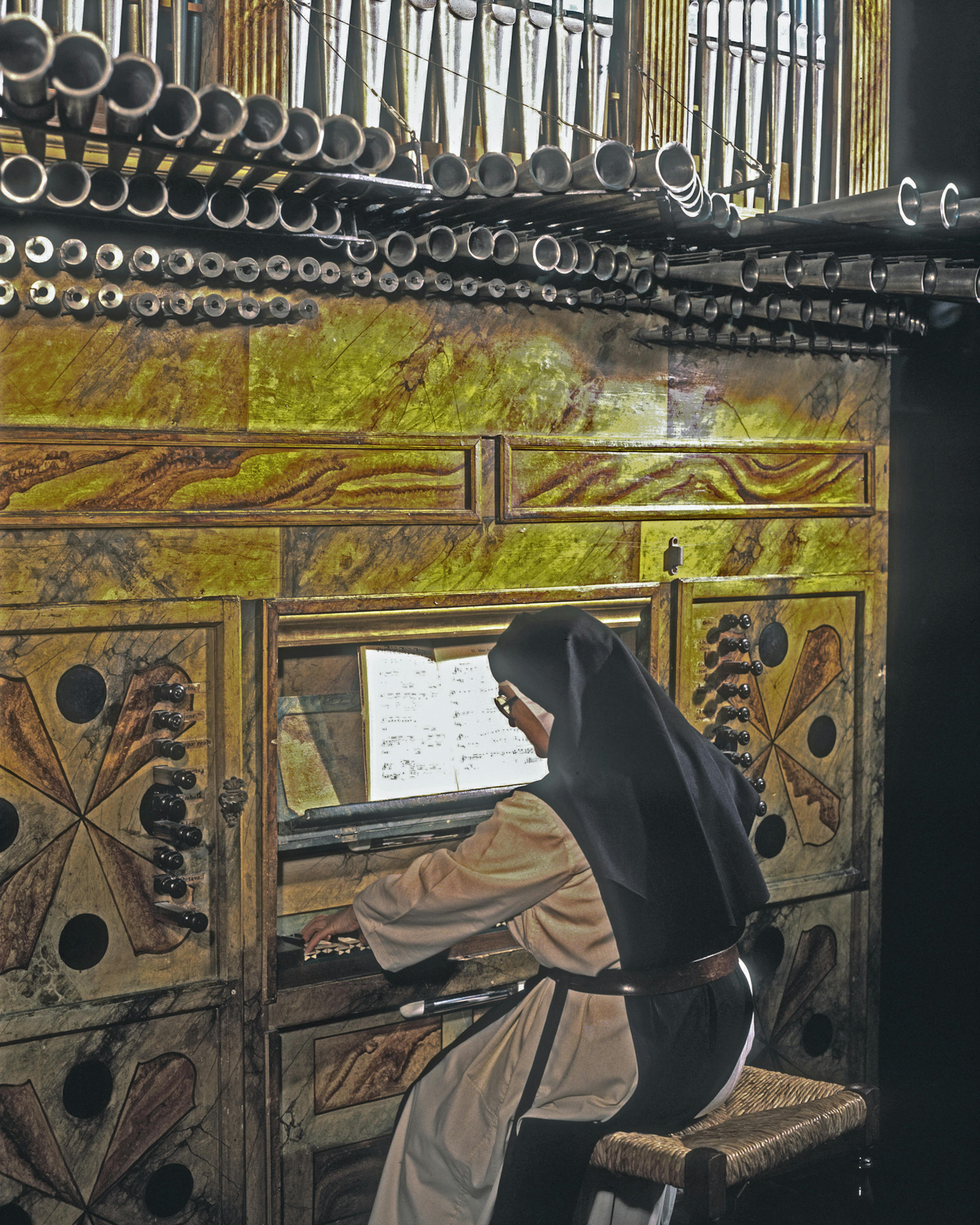 A nun playing the organ at the Convent of San Clemente, built over 700 years ago, 2003